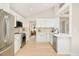 Modern kitchen with white cabinets, stainless steel appliances, and light wood floors at 6716 W 97Th Cir, Broomfield, CO 80021