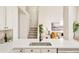 Kitchen features white cabinets, quartz countertops, and a farmhouse sink at 6716 W 97Th Cir, Broomfield, CO 80021