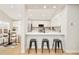 Modern kitchen with white cabinets, quartz countertops, and a breakfast bar at 6716 W 97Th Cir, Broomfield, CO 80021