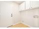 Bright laundry room featuring white cabinets and wood-look floors at 6716 W 97Th Cir, Broomfield, CO 80021