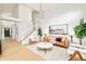 Living area with white shiplap feature wall, hardwood floors, and comfy seating at 6716 W 97Th Cir, Broomfield, CO 80021