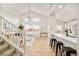 Open concept living area with white shiplap wall and hardwood floors at 6716 W 97Th Cir, Broomfield, CO 80021