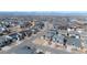 Aerial view of neighborhood homes and street layout with mountains in the distance at 211 Luna Ct, Erie, CO 80516