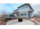 View of the backyard patio and house featuring stone accents at 211 Luna Ct, Erie, CO 80516