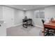 View of the carpeted basement area with desk space and egress window at 211 Luna Ct, Erie, CO 80516
