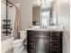 Bathroom showcasing vanity and tile shower with a decorative shower curtain at 211 Luna Ct, Erie, CO 80516