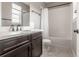 Bathroom featuring a vanity with solid surface counters and a tub with tile surround at 211 Luna Ct, Erie, CO 80516