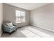 Bright bedroom featuring a window view and cozy sitting chair at 211 Luna Ct, Erie, CO 80516