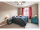 Bedroom featuring red curtains, a ceiling fan and an accent lamp at 211 Luna Ct, Erie, CO 80516
