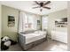 Light-filled bedroom with decorative artwork, a ceiling fan, and large windows at 211 Luna Ct, Erie, CO 80516
