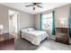 Comfortable bedroom with neutral walls, a ceiling fan, and natural light from the window at 211 Luna Ct, Erie, CO 80516