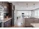 Bright modern kitchen with stainless appliances opens to a cozy living space at 211 Luna Ct, Erie, CO 80516