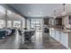 Open-concept kitchen and dining area with modern appliances and wood floors at 211 Luna Ct, Erie, CO 80516