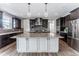 Modern kitchen featuring a large island, stainless steel appliances, and pendant lighting at 211 Luna Ct, Erie, CO 80516