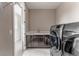 Well-equipped laundry room with modern washer, dryer, and ample counter space at 211 Luna Ct, Erie, CO 80516