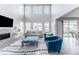 Bright living room with high ceilings, fireplace, comfortable seating, and many windows at 211 Luna Ct, Erie, CO 80516