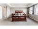 A carpeted main bedroom with a beautiful bed and large windows for natural light at 211 Luna Ct, Erie, CO 80516