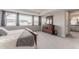 Spacious bedroom with wide windows, plush carpet, and stylish wooden dresser at 211 Luna Ct, Erie, CO 80516