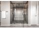 Luxurious shower features glass doors, a built-in bench, and sleek fixtures at 211 Luna Ct, Erie, CO 80516