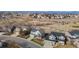Scenic aerial view of a neighborhood featuring well-maintained homes and green spaces, set against a mountain backdrop at 9957 Candlewood Ln, Highlands Ranch, CO 80126