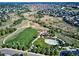 Aerial view of a community park with walking paths, tennis courts and playground at 9957 Candlewood Ln, Highlands Ranch, CO 80126