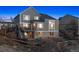 Rear exterior view of the house with a deck and spacious backyard at 9957 Candlewood Ln, Highlands Ranch, CO 80126
