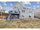 Back exterior view highlighting the deck, landscaping, and architecture at 9957 Candlewood Ln, Highlands Ranch, CO 80126