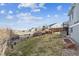 Expansive backyard with a lawn, fencing, garden beds, and view at 9957 Candlewood Ln, Highlands Ranch, CO 80126