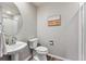 Clean bathroom featuring modern fixtures, pedestal sink, and shower at 9957 Candlewood Ln, Highlands Ranch, CO 80126