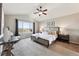 Serene main bedroom with a vaulted ceiling, abundant natural light, and scenic views at 9957 Candlewood Ln, Highlands Ranch, CO 80126