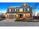 Inviting two-story home with a brick facade, solar panels and a well-manicured front yard at 9957 Candlewood Ln, Highlands Ranch, CO 80126