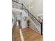 Elegant foyer with hardwood floors, staircase with iron railings, and stylish decor, creating a welcoming entrance at 9957 Candlewood Ln, Highlands Ranch, CO 80126