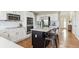 Modern kitchen with white cabinets, stainless steel appliances, and a stylish island with seating, perfect for cooking at 9957 Candlewood Ln, Highlands Ranch, CO 80126