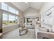 Open-concept living room featuring abundant natural light, fireplace, and seamless flow into the dining area at 9957 Candlewood Ln, Highlands Ranch, CO 80126
