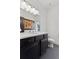 Stylish bathroom with dark vanity, toilet and a quartz countertop at 1312 Jade Ln, Longmont, CO 80504