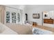 Bedroom with king bed, sitting area, and access to bathroom at 1312 Jade Ln, Longmont, CO 80504