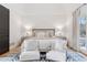 Bright bedroom with king-size bed and sitting area at 1312 Jade Ln, Longmont, CO 80504