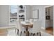 Bright dining room with a view, hardwood floors, and built-in shelving at 1312 Jade Ln, Longmont, CO 80504
