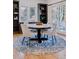Bright dining room with round table and blue rug at 1312 Jade Ln, Longmont, CO 80504