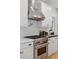 Modern kitchen with stainless steel range hood and stove at 1312 Jade Ln, Longmont, CO 80504