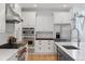 Modern kitchen with stainless steel appliances and white shaker cabinets at 1312 Jade Ln, Longmont, CO 80504