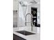 Modern kitchen with stainless steel faucet and farmhouse sink at 1312 Jade Ln, Longmont, CO 80504