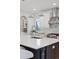 Modern kitchen with white cabinets, stainless steel appliances, and large island at 1312 Jade Ln, Longmont, CO 80504