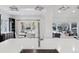 Modern kitchen island with a farmhouse sink and a view into the dining area at 1312 Jade Ln, Longmont, CO 80504