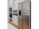 Modern kitchen with stainless steel refrigerator and built-in microwave at 1312 Jade Ln, Longmont, CO 80504