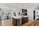 Open concept kitchen with island, stainless steel appliances, and a view into Gathering room at 1312 Jade Ln, Longmont, CO 80504