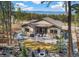Stunning backyard featuring a patio, fire pit, manicured lawn, and scenic mountain views beyond the treeline at 878 Tree Bark Ter, Colorado Springs, CO 80132