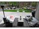 Spacious backyard with an outdoor seating area, fire pit, lush greenery, and a tranquil waterfall feature at 878 Tree Bark Ter, Colorado Springs, CO 80132