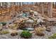Backyard waterfall feature adding tranquility, surrounded by lush greenery and a wooden fence at 878 Tree Bark Ter, Colorado Springs, CO 80132