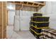 Unfinished basement storage space with stacked storage containers at 878 Tree Bark Ter, Colorado Springs, CO 80132